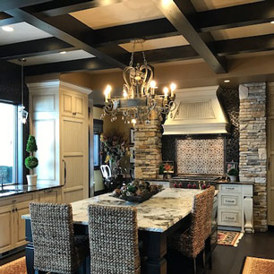 Kitchen featuring wood flooring, granite, marble, chandelier and pendant lighting, wood beams, custom cabinets and tile